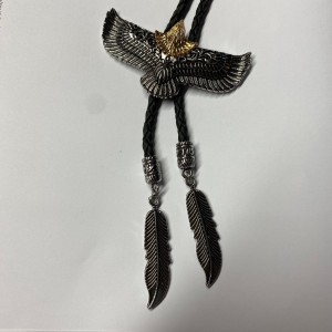 Bolo tie with golden headed egale and feather tips